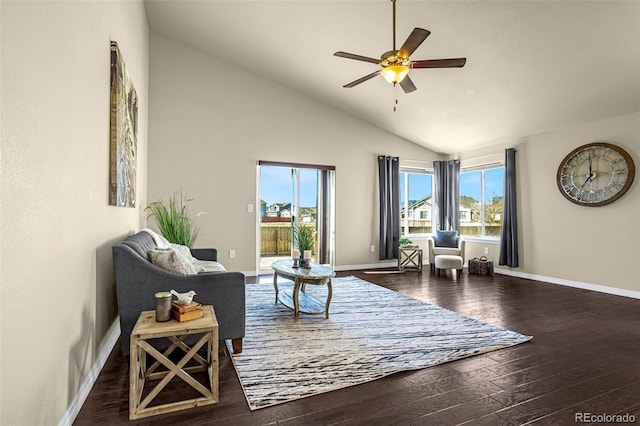 living area featuring baseboards, hardwood / wood-style floors, and a ceiling fan