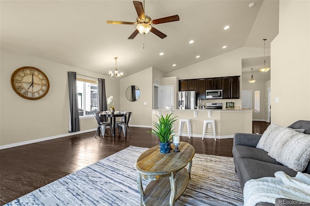 living area featuring high vaulted ceiling, ceiling fan with notable chandelier, dark wood finished floors, recessed lighting, and baseboards