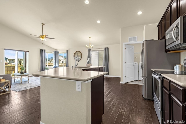 kitchen with stainless steel appliances, light countertops, vaulted ceiling, dark brown cabinets, and ceiling fan with notable chandelier