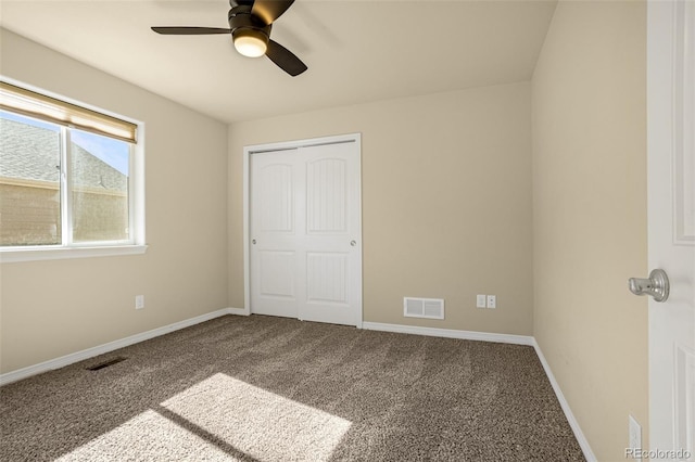 unfurnished bedroom featuring visible vents, baseboards, carpet floors, and a closet