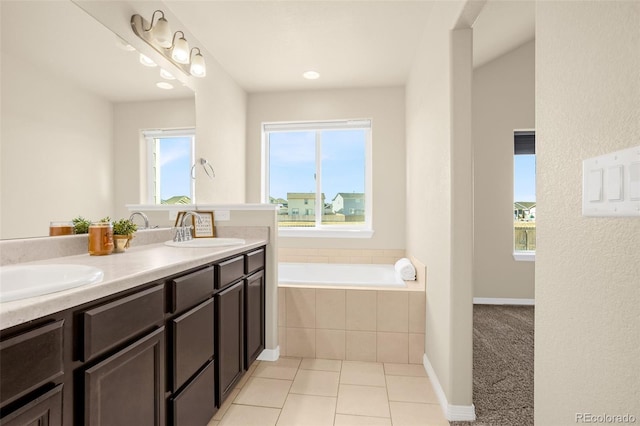 bathroom with a sink, plenty of natural light, and a garden tub