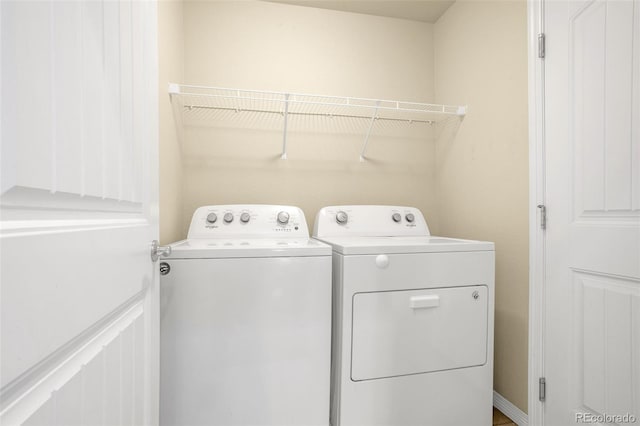 washroom featuring laundry area and washer and clothes dryer