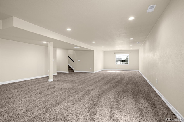 below grade area featuring visible vents, recessed lighting, carpet floors, baseboards, and stairs