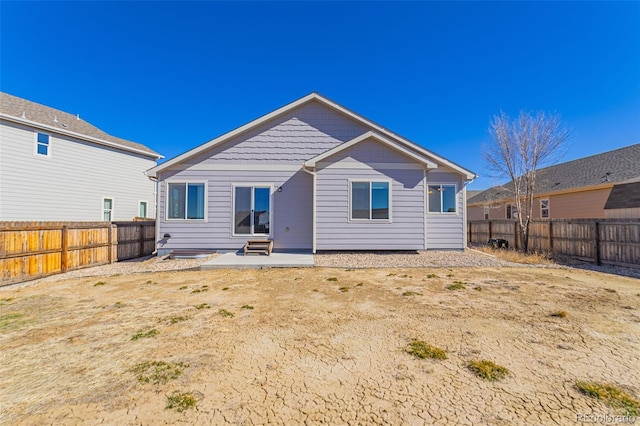 back of house featuring a patio and a fenced backyard