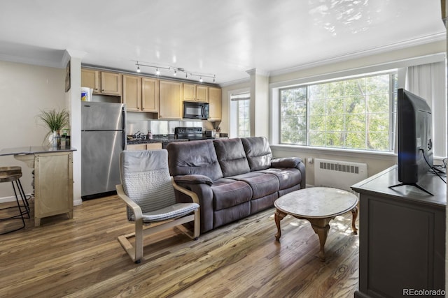 1450 Albion St Unit 206, Denver, CO 80220 - living area featuring radiator heating unit, ornamental molding, wood finished floors, and rail lighting