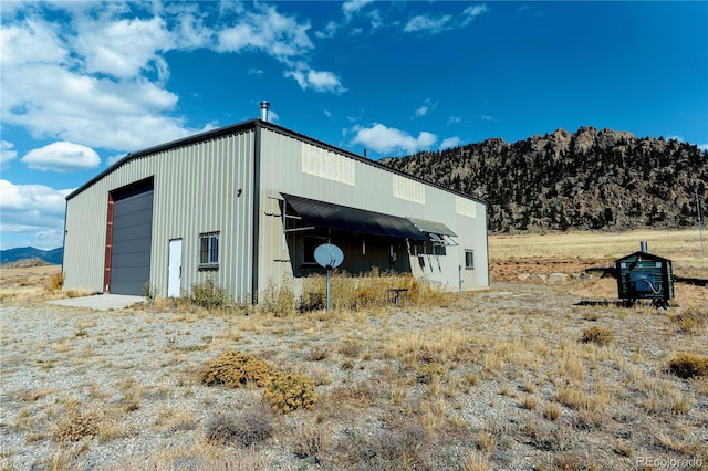 view of outbuilding with a mountain view and a garage