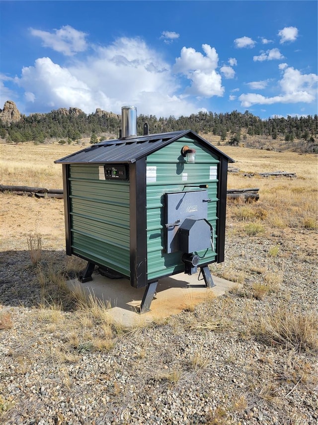 view of outdoor structure with a rural view