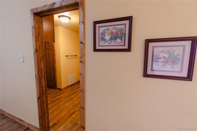 corridor featuring wood-type flooring