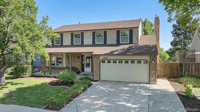 1121 W Kettle Ave, Littleton, CO 80120 - view of front of house with driveway, brick siding, a shingled roof, and an attached garage