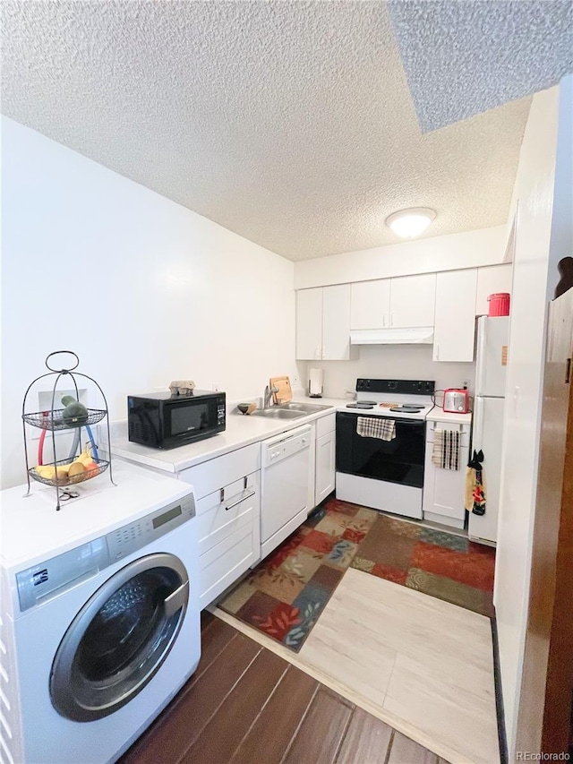 kitchen featuring white appliances, a textured ceiling, white cabinetry, dark hardwood / wood-style floors, and washer / dryer