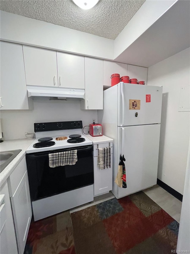 kitchen with a textured ceiling, white appliances, sink, and white cabinets