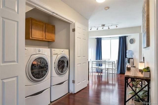 laundry room with cabinets, rail lighting, washing machine and clothes dryer, and dark hardwood / wood-style flooring