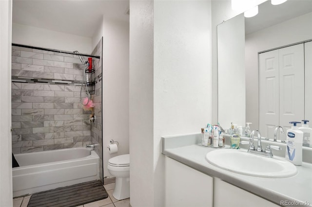 full bathroom featuring tiled shower / bath combo, tile patterned flooring, vanity, and toilet