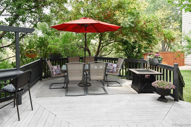 wooden deck featuring an outdoor fire pit