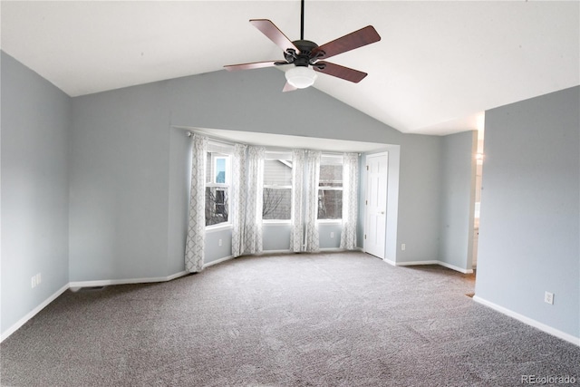 carpeted spare room with ceiling fan and vaulted ceiling