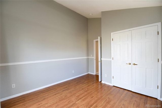 unfurnished bedroom featuring light wood-type flooring and a closet