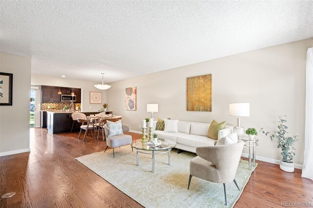 4452 W Pondview Dr, Littleton, CO 80123 - living room featuring wood finished floors and a textured ceiling