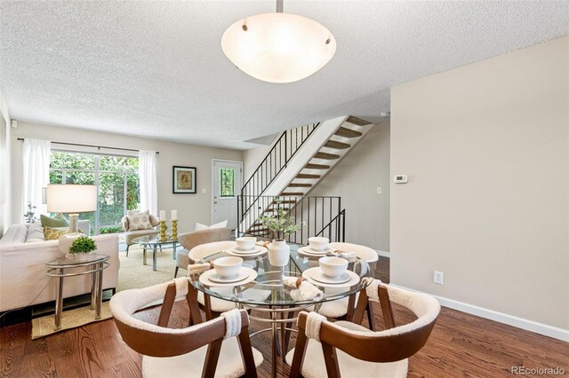4452 W Pondview Dr, Littleton, CO 80123 - dining room featuring wood finished floors, a textured ceiling, and stairway