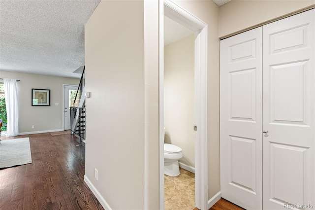 4452 W Pondview Dr, Littleton, CO 80123 - hallway featuring wood finished floors, a textured ceiling, and stairway