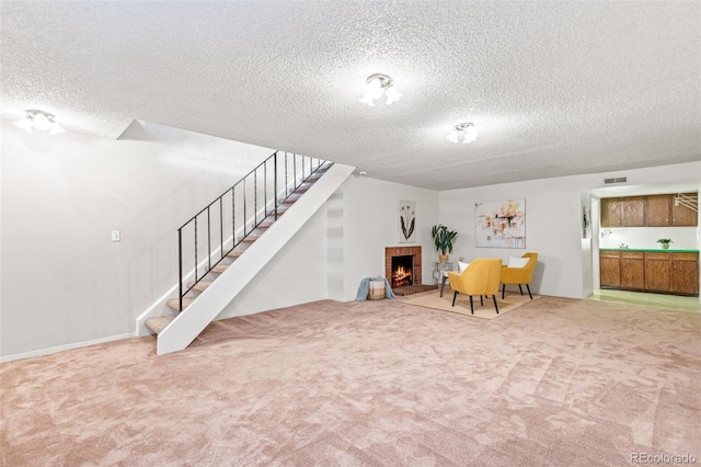 4452 W Pondview Dr, Littleton, CO 80123 - living area with carpet flooring, a fireplace, a textured ceiling, and stairway