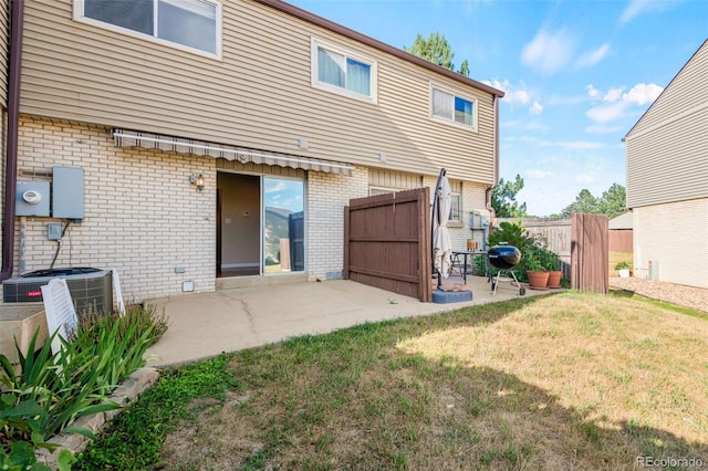4452 W Pondview Dr, Littleton, CO 80123 - back of house featuring brick siding and a patio area