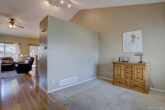 interior space with visible vents, baseboards, lofted ceiling, and carpet flooring