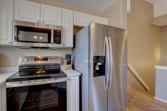 kitchen with white cabinetry, appliances with stainless steel finishes, and light countertops