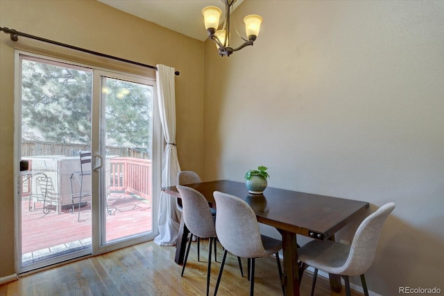 dining room featuring a notable chandelier and wood finished floors