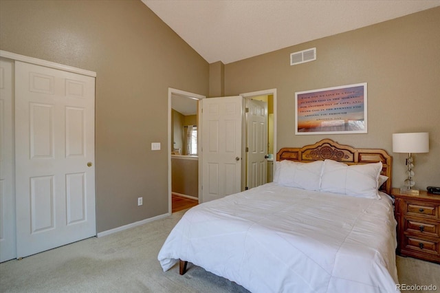 carpeted bedroom with vaulted ceiling, baseboards, and visible vents