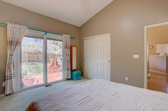 bedroom with visible vents, carpet, vaulted ceiling, a closet, and access to outside