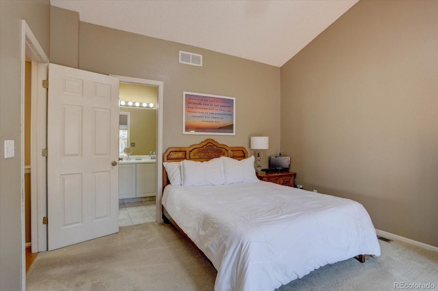 bedroom with visible vents, connected bathroom, baseboards, light colored carpet, and vaulted ceiling