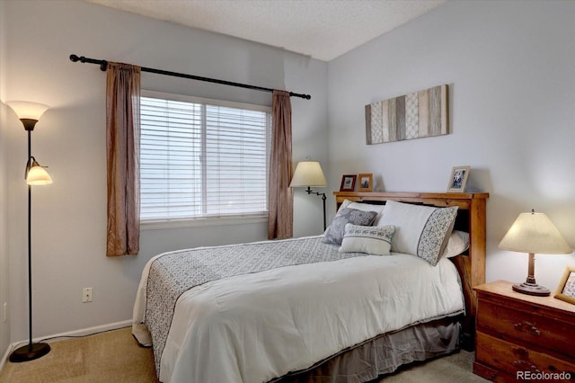 bedroom featuring baseboards, carpet, and a textured ceiling