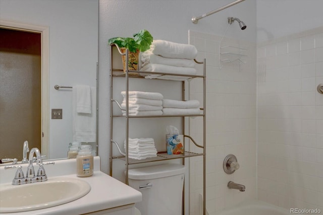 full bath featuring vanity, toilet, and washtub / shower combination