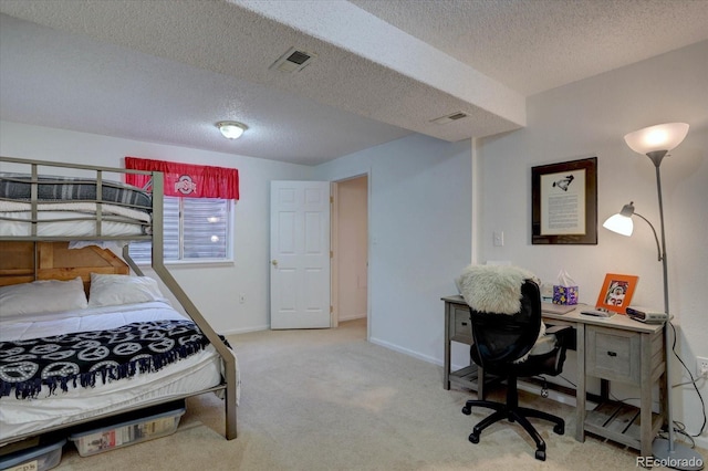 bedroom featuring baseboards, visible vents, carpet floors, and a textured ceiling