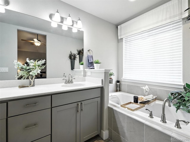 full bathroom with vanity, a garden tub, and a ceiling fan