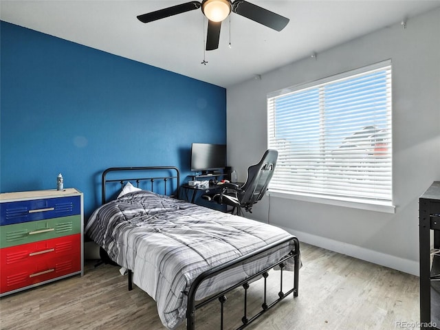 bedroom with wood finished floors and a ceiling fan
