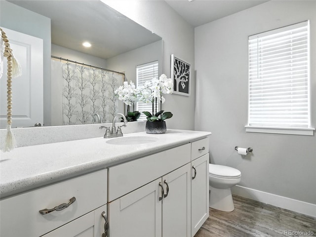 full bathroom with vanity and wood finished floors