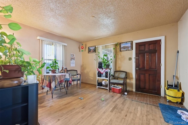 interior space with a textured ceiling and light wood-type flooring