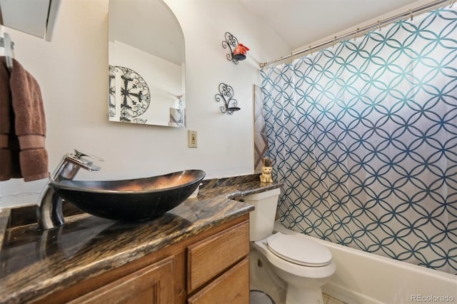 full bathroom with vanity, shower / tub combo, and toilet