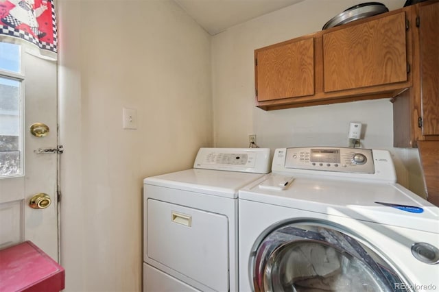 washroom featuring cabinets, independent washer and dryer, and a healthy amount of sunlight