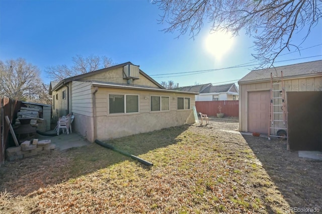 view of home's exterior with an outdoor structure and a yard