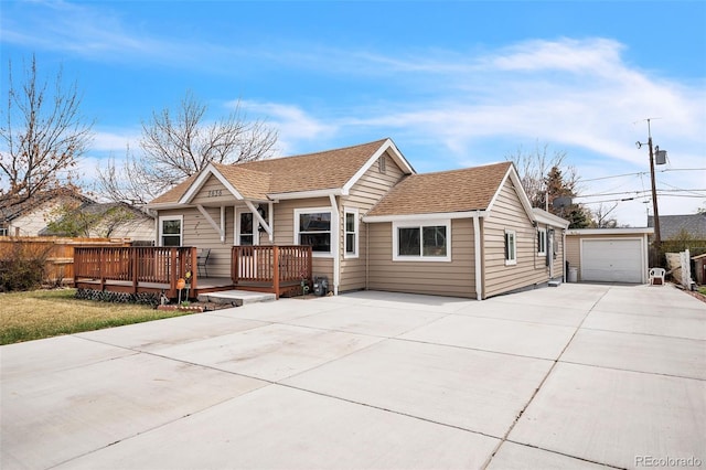 3656 W 77th Ave, Westminster, CO 80030 - view of front of property with concrete driveway, a deck, an outbuilding, and roof with shingles