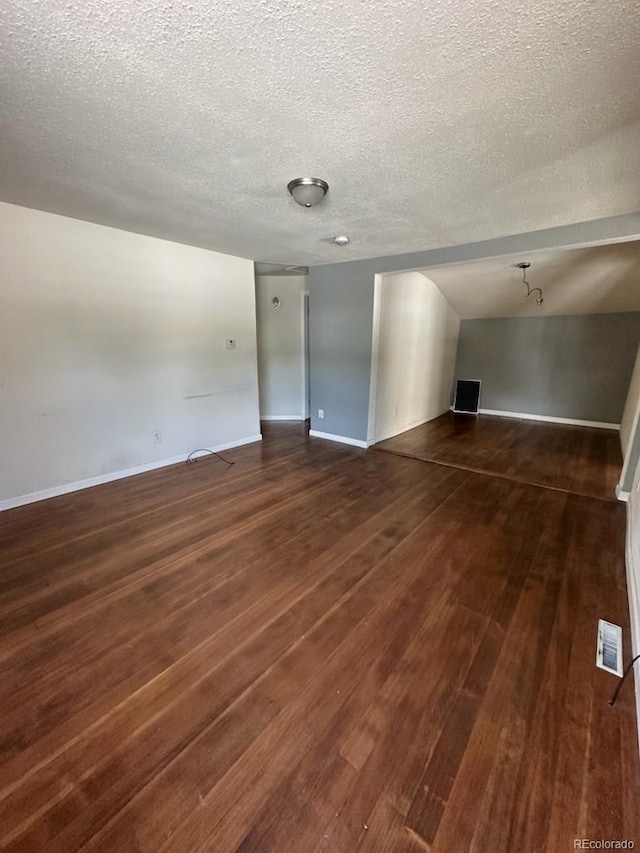 3656 W 77th Ave, Westminster, CO 80030 - unfurnished living room featuring dark wood-style flooring and a textured ceiling