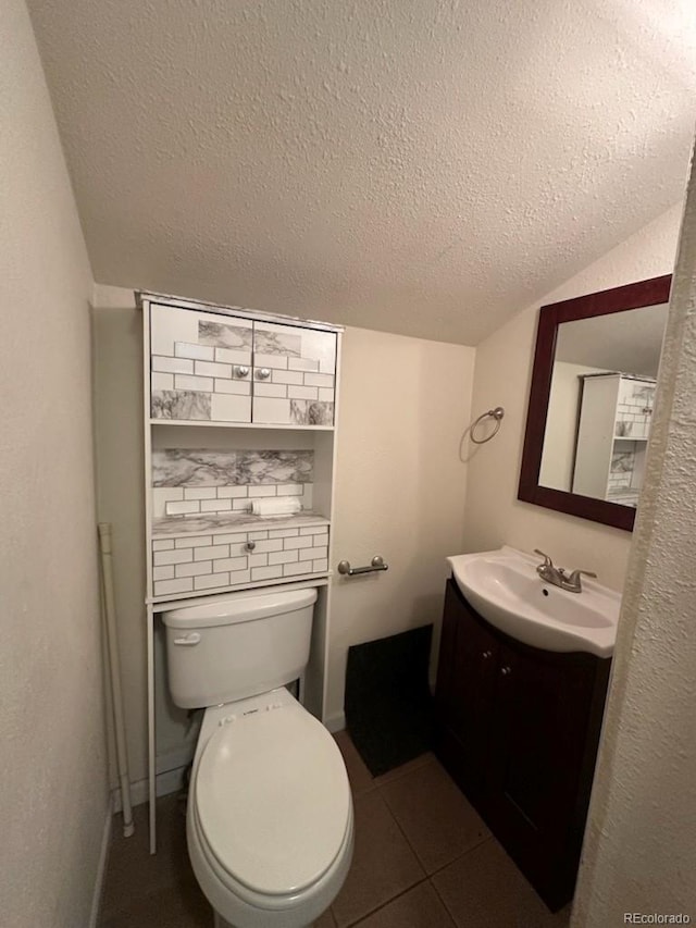 3656 W 77th Ave, Westminster, CO 80030 - half bathroom featuring vanity, a textured ceiling, and tile patterned floors