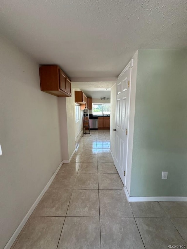 3656 W 77th Ave, Westminster, CO 80030 - corridor with light tile patterned floors and a textured ceiling