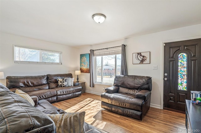 living area featuring baseboards and wood finished floors