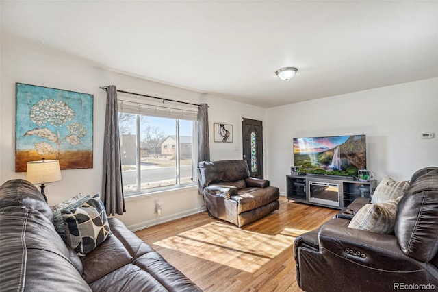 living area featuring wood finished floors and baseboards