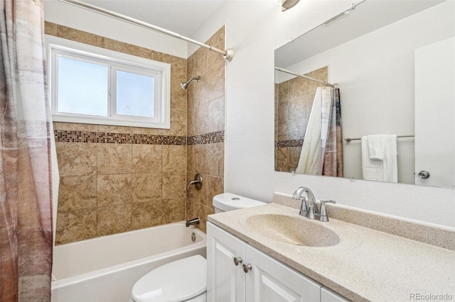 bathroom featuring toilet, shower / bath combo with shower curtain, and vanity