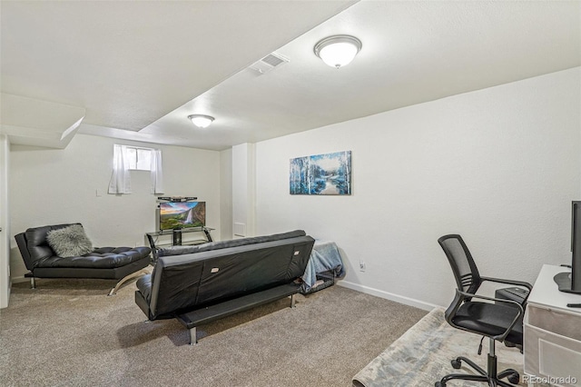 carpeted office space featuring visible vents and baseboards