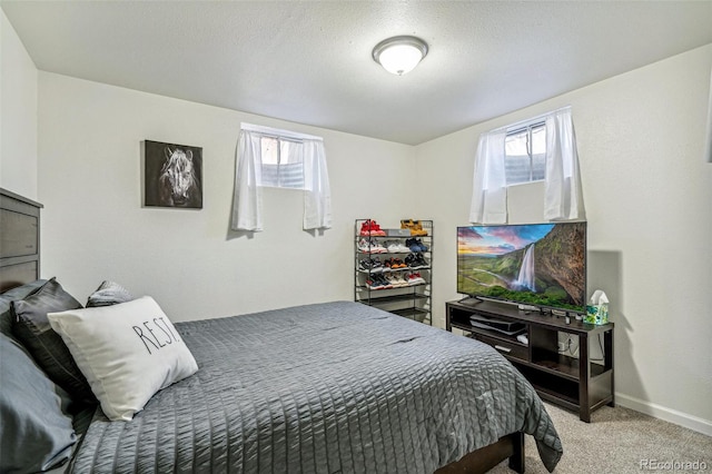 carpeted bedroom with baseboards